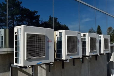 An air conditioning unit installed on a building in Ballarat VIC provides cooling relief during a hot summer day.